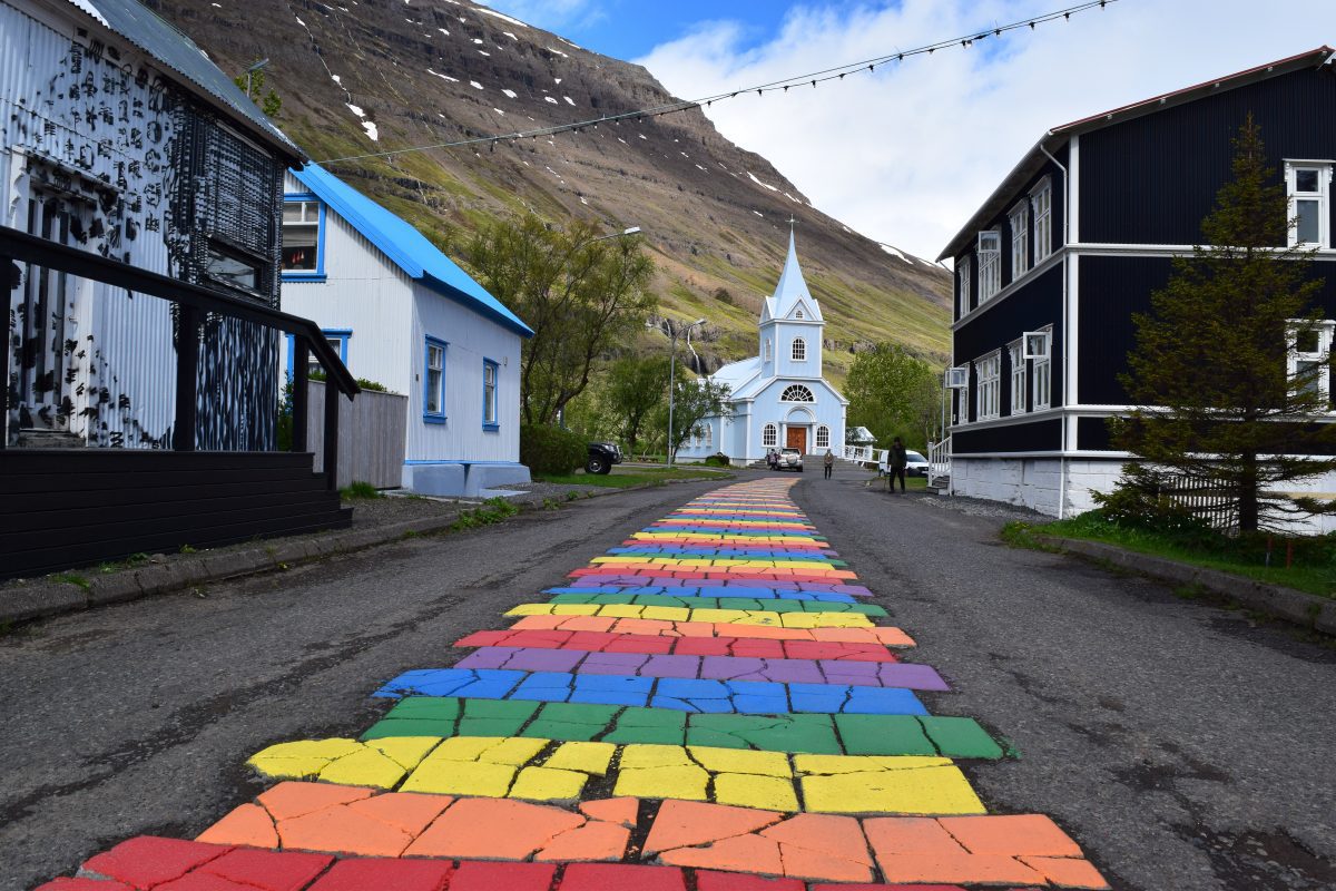 blue church and rainbow road in Seydisfjordur