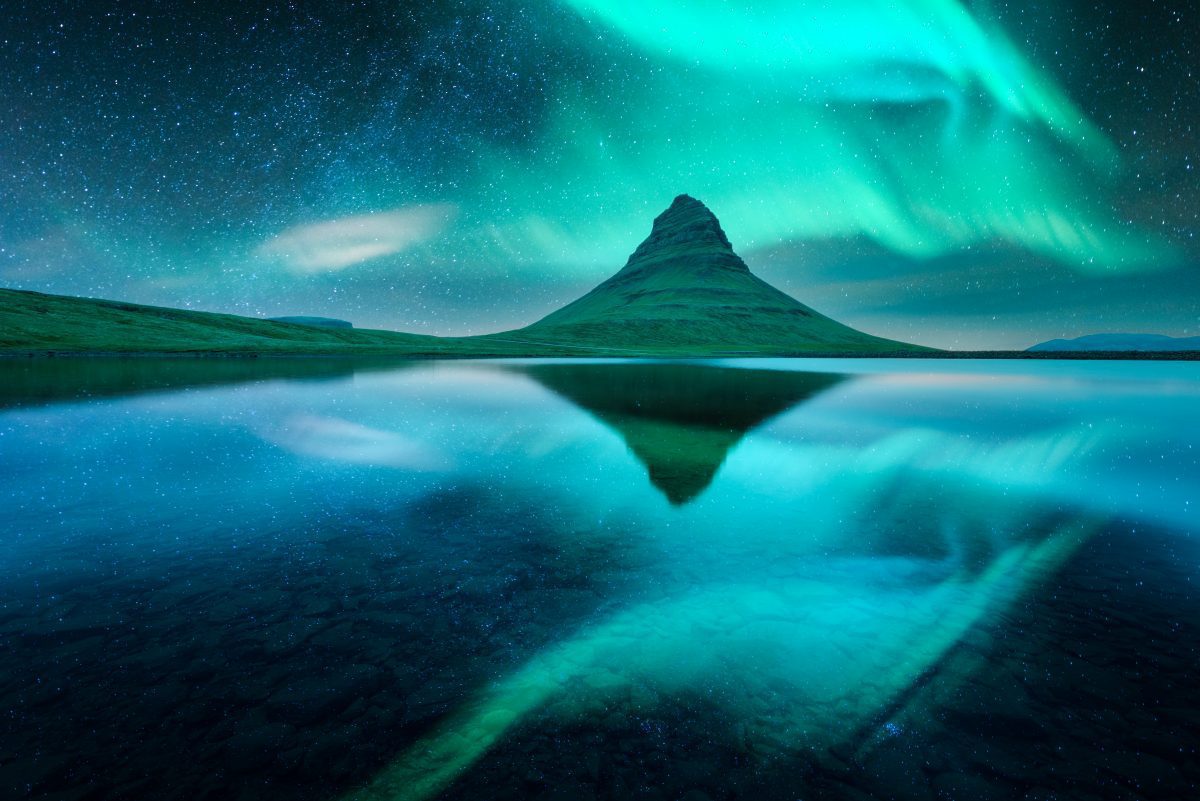 kirkjufell mountain under the northern lights in iceland